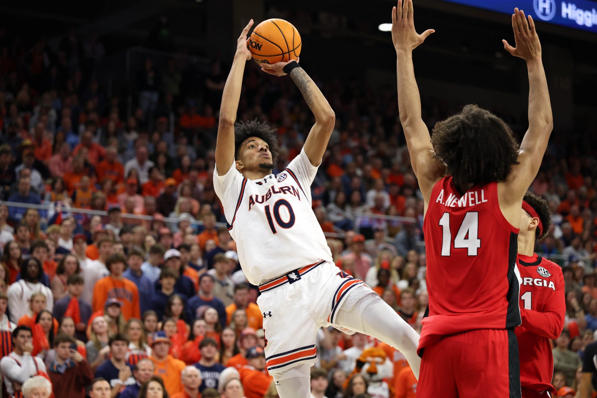 Auburn Tigers guard Chad Baker-Mazara (10) takes a shot against Georgia Bulldogs forward Asa Newell (14) during the second half at Neville Arena.