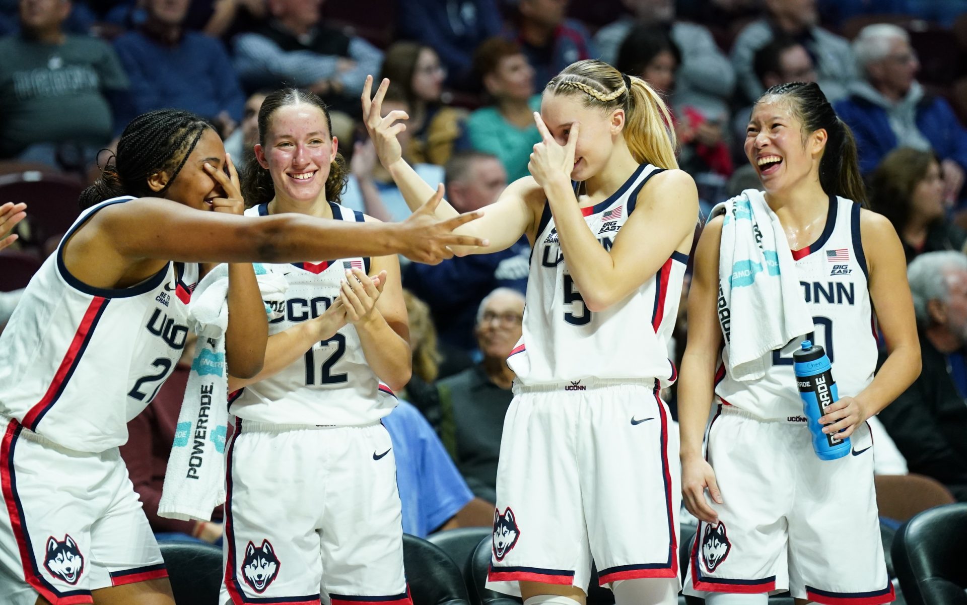 UConn Huskies forward Sarah Strong (21), guard Ashlynn Shade (12), guard Paige Bueckers (5) and guard Kaitlyn Chen (20) react after a three point basket against the Iowa State Cyclones in the first half at Mohegan Sun Arena.