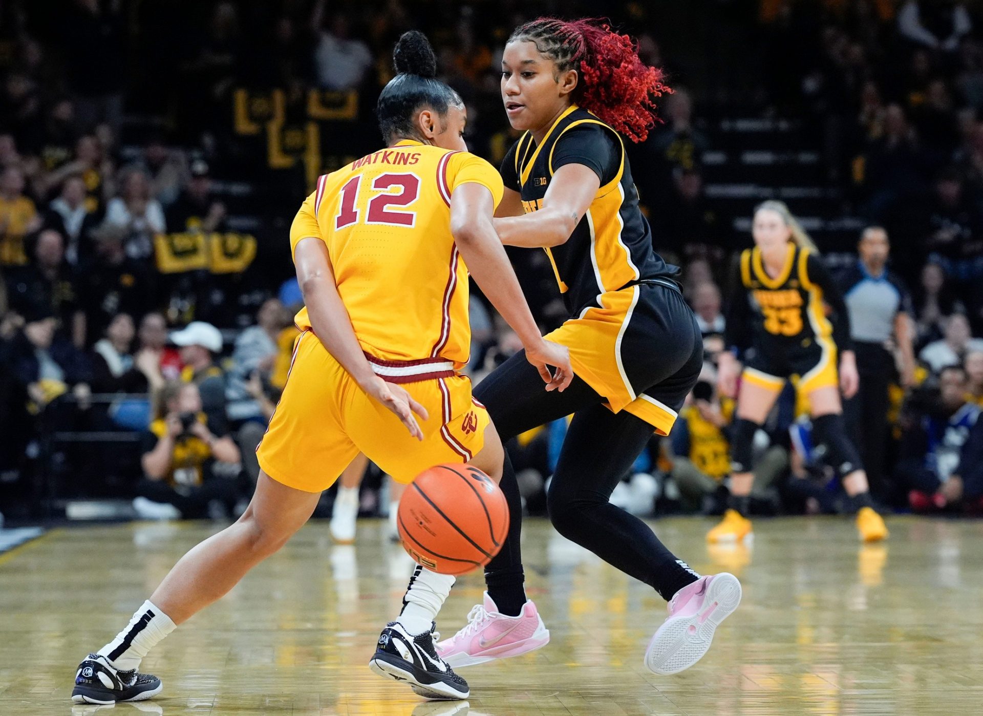 Iowa Hawkeyes guard Aaliyah Guyton (11) defends USC Trojans guard JuJu Watkins (12) as she brings the ball up court during a Big Ten women’s basketball game Sunday, Feb. 2, 2025 at Carver-Hawkeye Arena in Iowa City, Iowa.