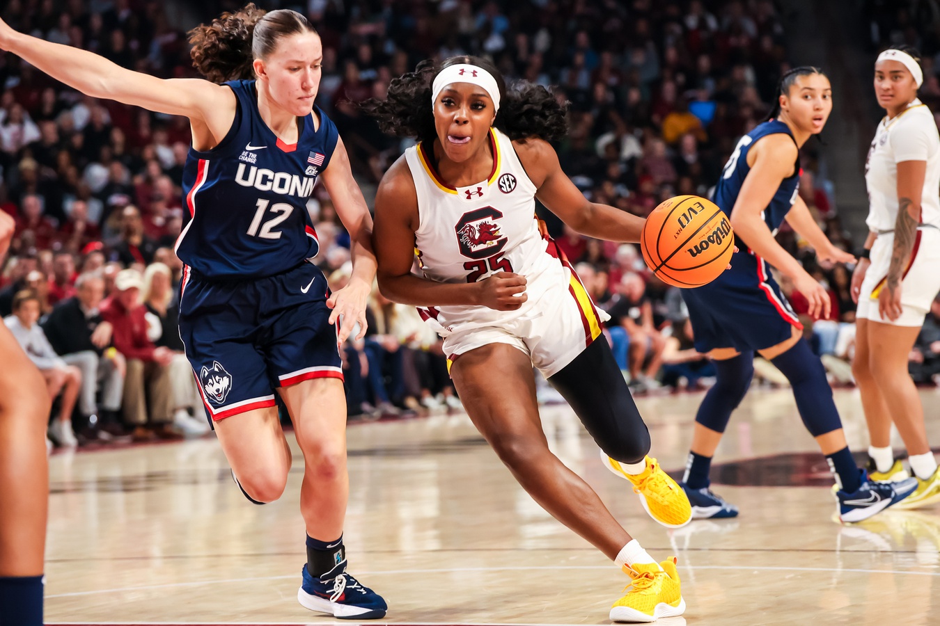 South Carolina Gamecocks guard Raven Johnson (25) drives around UConn Huskies guard Ashlynn Shade (12) in the first half at Colonial Life Arena.