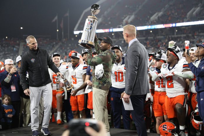 Syracuse Orange head coach Fran Brown raises the Holiday Bowl trophy after defeating the Washington State Cougars after the game at Snapdragon Stadium.