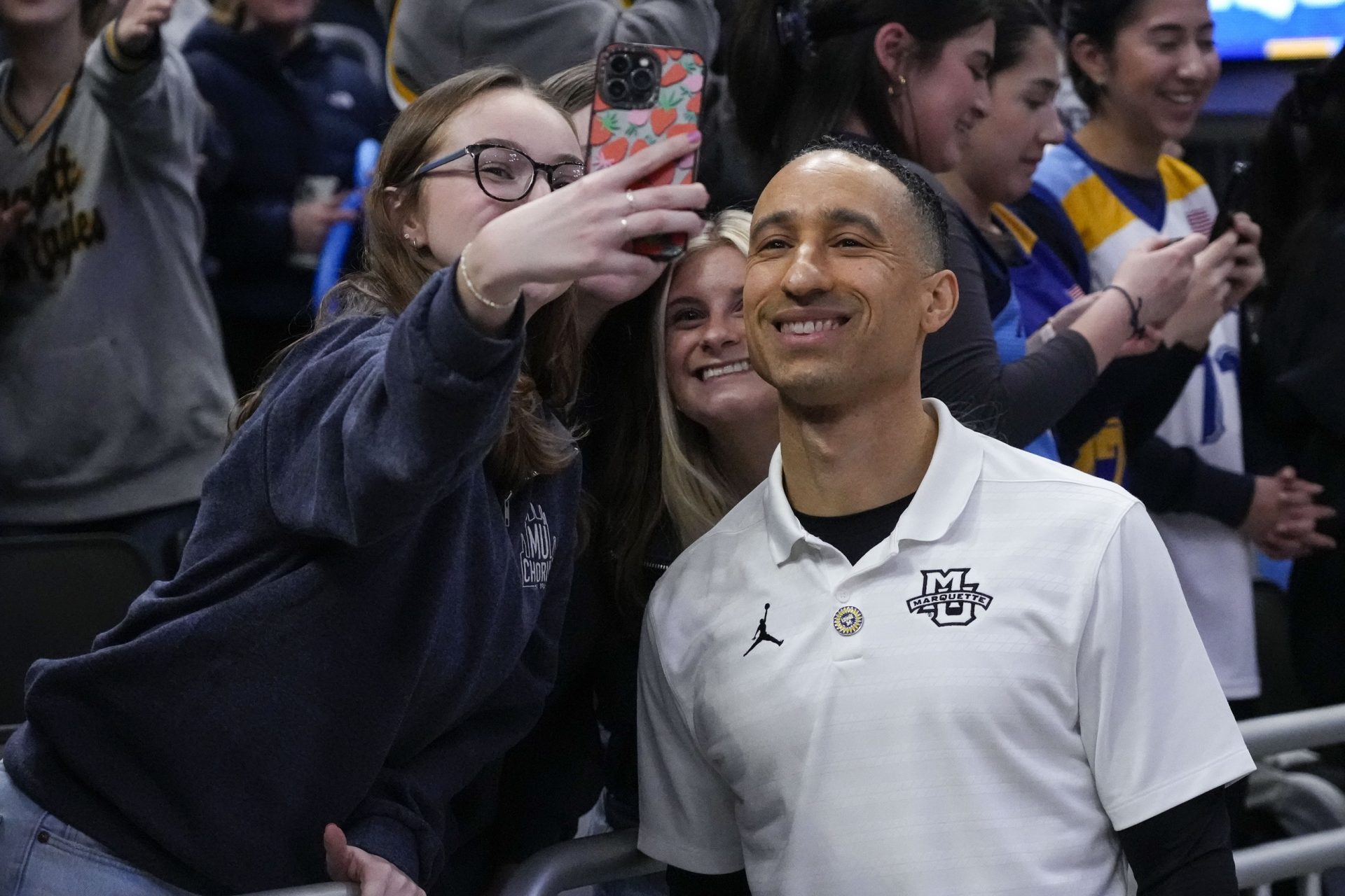 Marquette Golden Eagles head coach Shaka Smart posses for a photo wth fans following the game against the Providence Friars at Fiserv Forum.