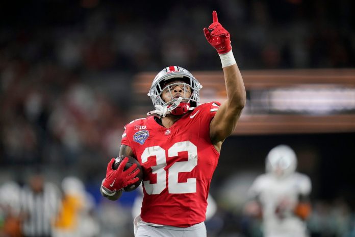 TreVeyon Henderson (32) scores a touchdown on a 75-yard touchdown catch and run against Texas Longhorns in the second quarter of the Cotton Bowl Classic during the College Football Playoff semifinal game at AT&T Stadium.