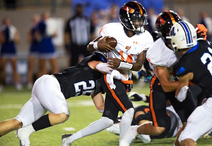 Hoover’s Jonah Winston (14) is stopped by Auburn High School's Camauri Russell (25) during their game at Cramton Bowl in Montgomery, Ala.