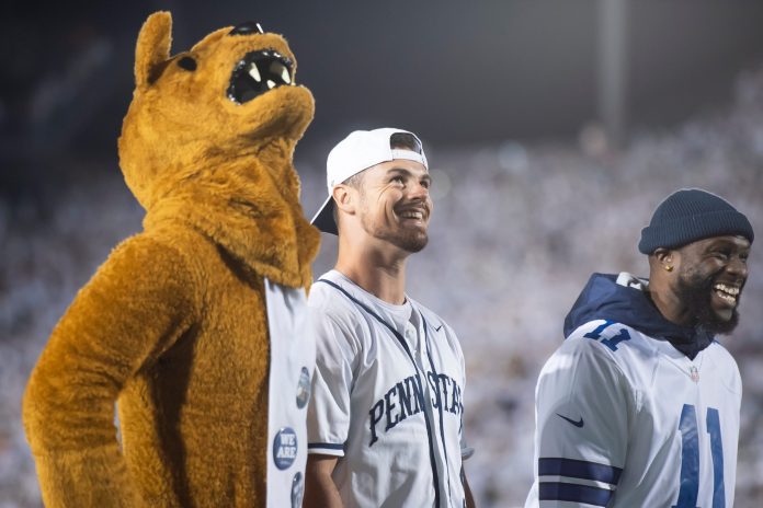 Penn State letterman Trace McSorley (center) smiles as some of his career highlights are played on the video board during a White Out game against Minnesota at Beaver Stadium on Saturday, Oct. 22, 2022, in State College.