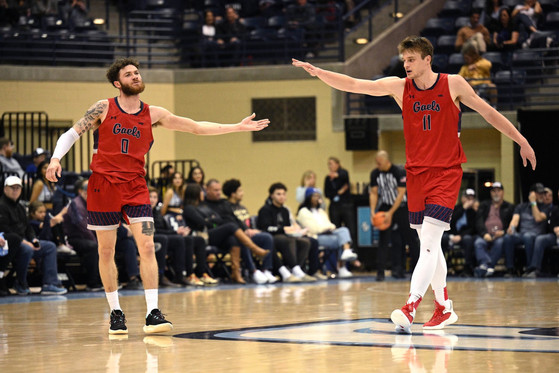 Saint Mary's Gaels guard Logan Johnson (0) and center Mitchell Saxen (11) celebrate during the second half against the San Diego Toreros at Jenny Craig Pavilion.