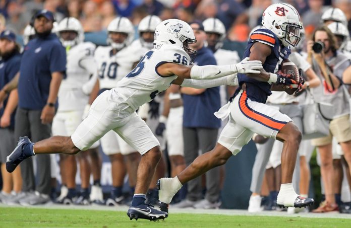 Auburn Tigers wide receiver Jay Fair (5) is stopped afewter a big gain by Samford Bulldogs defensive back Dontae Pollard (36) during first half action in the AU vs. Samford game at Jordan-Hare Stadium in the AU campus in Auburn, Ala., on Saturday September 16, 2023.