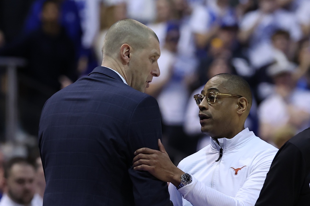 Brigham Young Cougars head coach Mark Pope and Texas Longhorns head coach Rodney Terry shake hands after a game at Marriott Center.