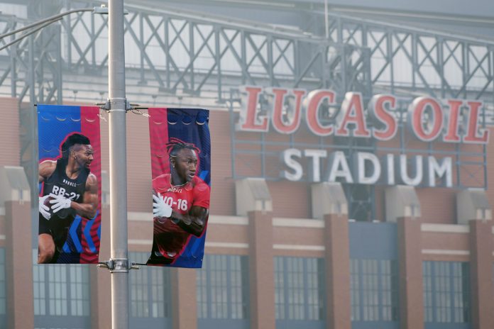 Banners featuring images of running back Bijan Robinson (left) and receiver Zay Flowers at the 2024 NFL Scouting Combine at Lucas Oil Stadium.