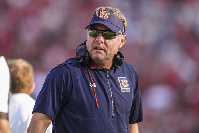 Auburn Tigers head coach Hugh Freeze on the field against the Georgia Bulldogs at Sanford Stadium.