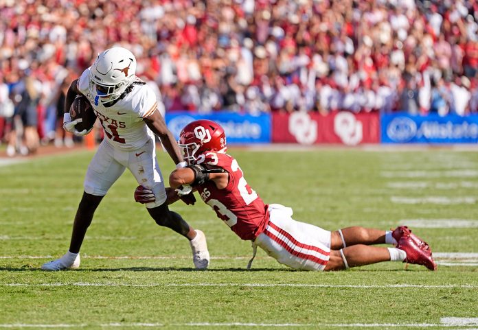 Texas Longhorns wide receiver Silas Bolden (11) is tackled by Oklahoma Sooners defensive back Eli Bowen (23) in the first half of the Red River Rivalry college football game between the University of Oklahoma Sooners and the Texas Longhorn at the Cotton Bowl Stadium in Dallas, Texas, Saturday, Oct., 12, 2024.