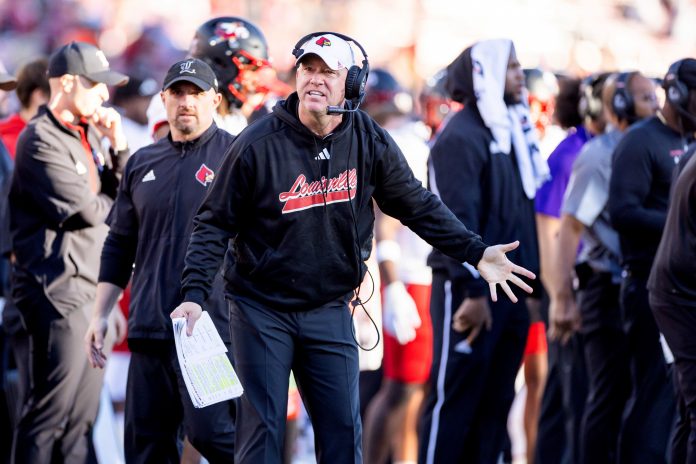 Louisville Cardinals head coach Jeff Brohm protests a call during the fourth quarter against the Stanford Cardinal at Stanford Stadium.