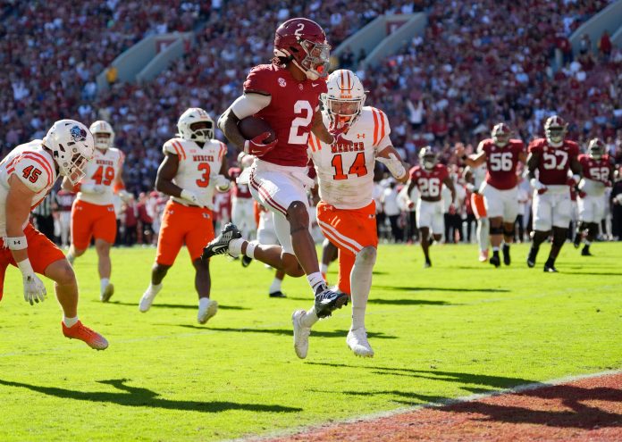 Alabama wide receiver Ryan Williams (2) leaps past Mercer safety Chris Joines (14) as he scores at Bryant-Denny Stadium.