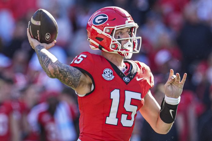 Georgia Bulldogs quarterback Carson Beck (15) in action against the Massachusetts Minutemen at Sanford Stadium.