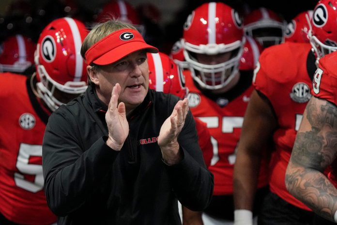 Georgia coach Kirby Smart takes the field with his team before the start of the SEC championship game against Texas in Atlanta.