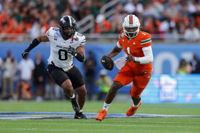 Miami Hurricanes quarterback Cam Ward (1) runs with the ball against the Iowa State Cyclones in the second quarter during the Pop Tarts bowl at Camping World Stadium.