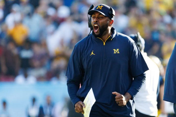 Michigan Wolverines head coach Sherrone Moore screams from the sideline against the Alabama Crimson Tide during the second half at Raymond James Stadium.