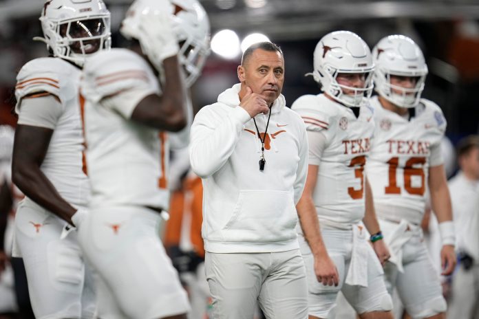 Texas Longhorns head coach Steve Sarkisian leads warm ups prior to the Cotton Bowl Classic College Football Playoff semifinal game between the Ohio State Buckeyes and the Texas Longhorns at AT&T Stadium in Arlington, Texas on Jan. 10, 2025.