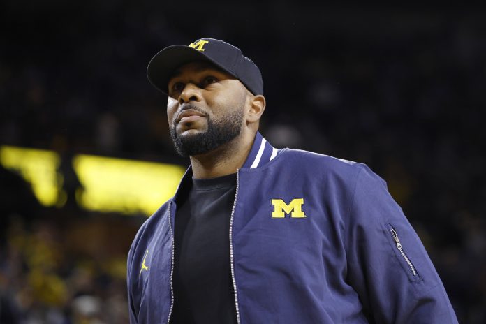 Michigan Wolverines head football coach Sherrone Moore fires up the crowd in overtime of the basketball game against the Northwestern Wildcats at Crisler Center.