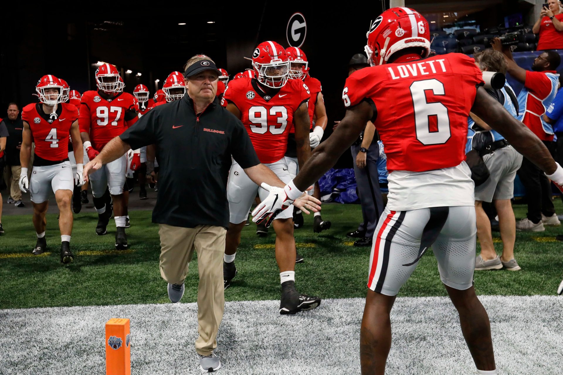 Georgia coach Kirby Smart leads his team onto the field for warm ups