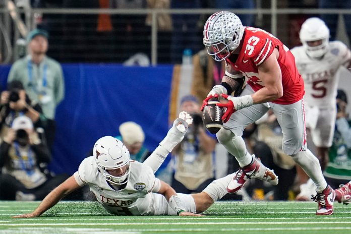 Ohio State Buckeyes defensive end Jack Sawyer (33) sacks Texas Longhorns quarterback Quinn Ewers (3) forcing a fumble during the second half of the Cotton Bowl Classic College Football Playoff semifinal game at AT&T Stadium in Arlington, Texas on Jan. 10, 2025.