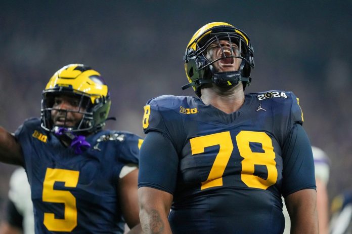 Michigan defensive lineman Kenneth Grant celebrates a sack on Washington quarterback Michael Penix Jr. during the College Football Playoff national championship game against Washington at NRG Stadium in Houston, Texas, on Monday, Jan. 8, 2024.