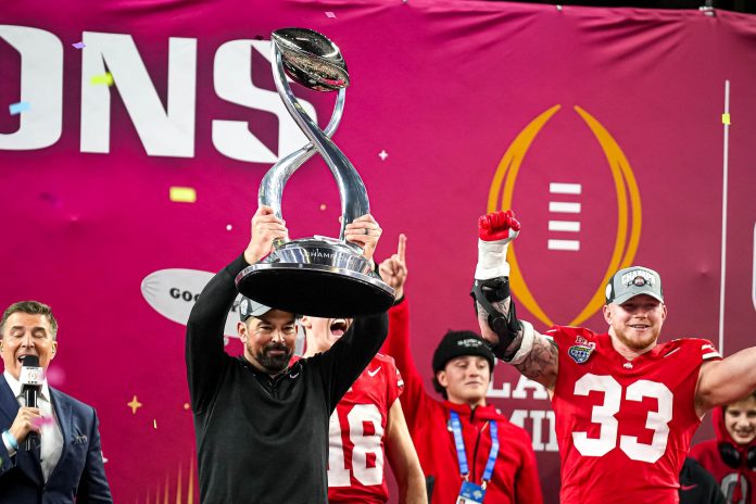 Ohio State head coach Ryan Day holds up the the College Football Playoff semifinal trophy after the 28-14 win over the Texas Longhorns in the Cotton Bowl at AT&T Stadium on Friday, Jan. 10, 2024 in Arlington, Texas.