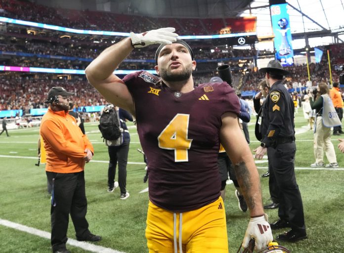 Arizona State running back Cam Skattebo (4) blows a kiss toward fans after Texas won 39-31 in double overtime in the Chick-fil-A Peach Bowl in Atlanta on Jan. 1, 2025.