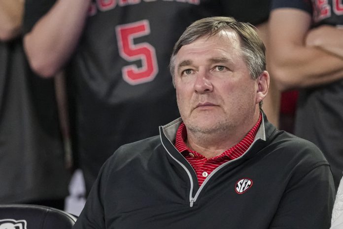 Kirby Smart watches the basketball game between Georgia and the Florida Gators