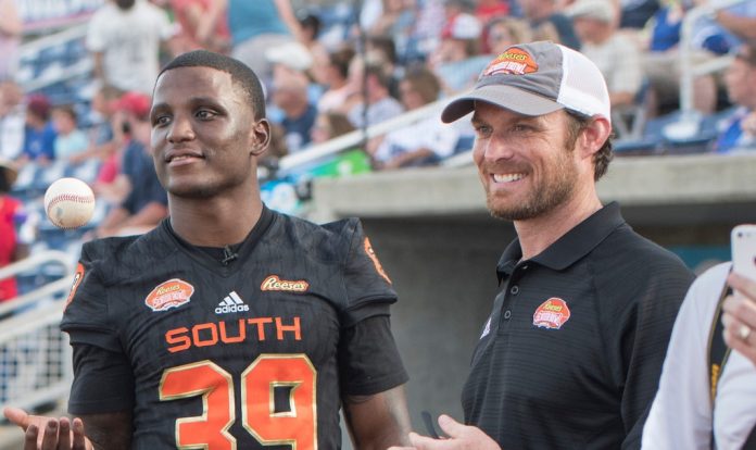 Jeremy Reaves, a Pensacola Catholic grad and current Washington safety, left, and Jim Nagy, new executive director of the Reeses Senior Bowl, hang out on the field during Reeses Senior Bowl Night at Blue Wahoos Stadium in Pensacola on Wednesday, June 26, 2019.