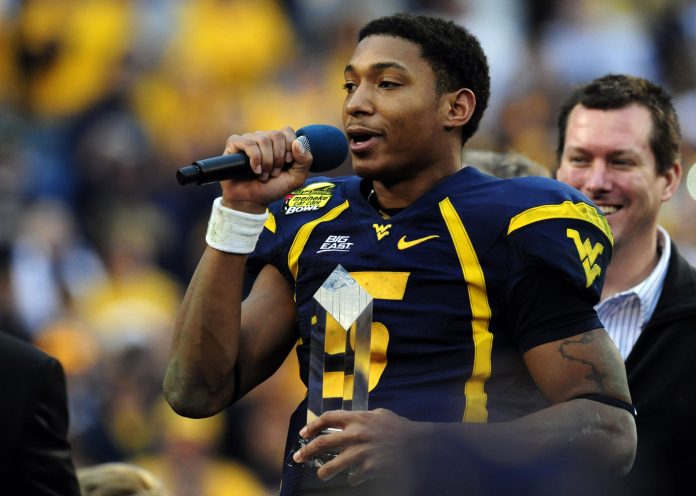 West Virginia Mountaineers quarterback Pat White (5) speaks to the fans while holding the game most valuable player award after his teams win over the North Carolina Tar Heels in the Meineke Car Care Bowl at Bank of America Stadium.