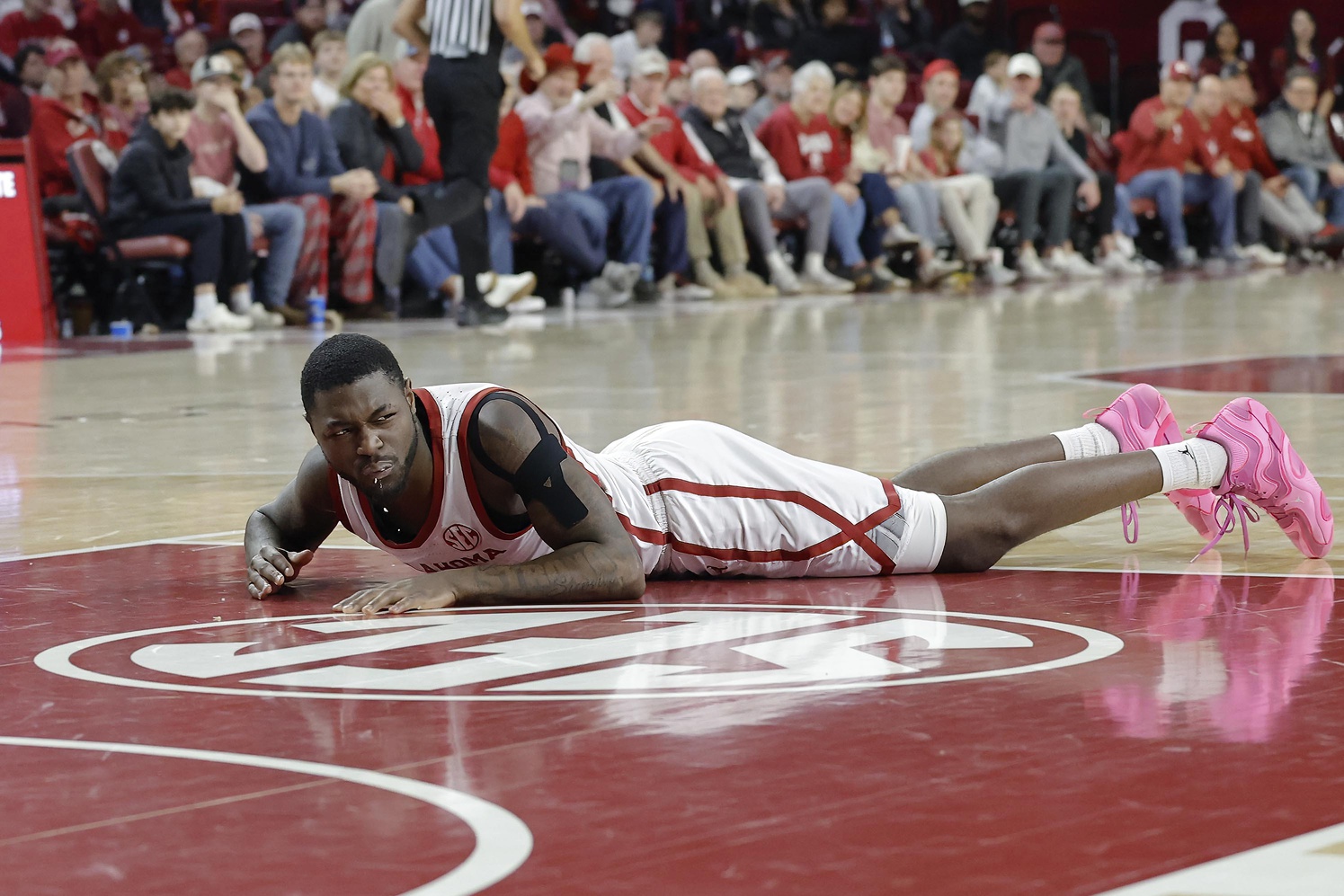 Oklahoma Sooners guard Duke Miles (15) breaks a tooth after falling to the floor during a play against Mississippi State Bulldogs during the second half at Lloyd Noble Center.