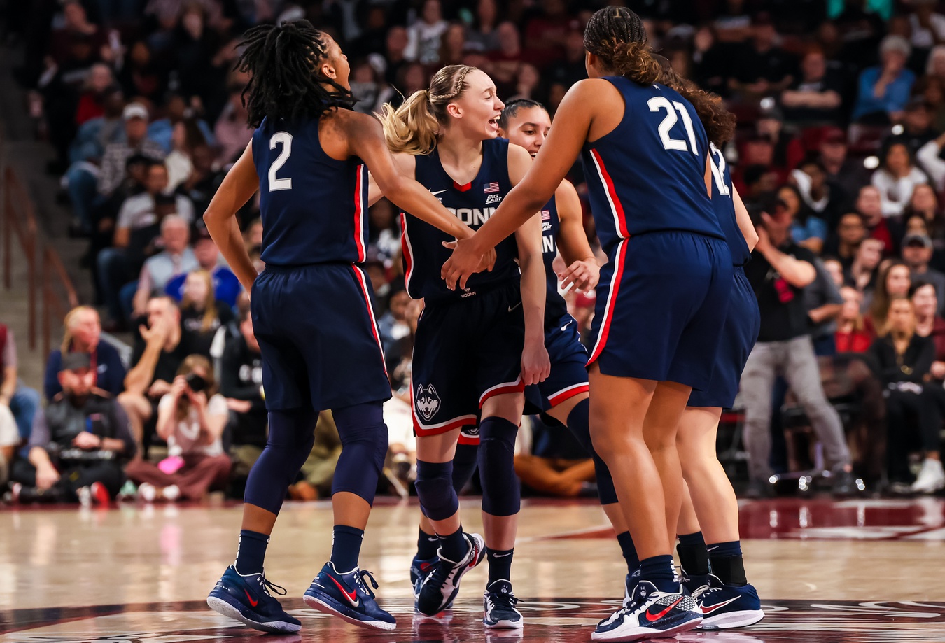 UConn Huskies guard KK Arnold (2), guard Paige Bueckers (5) and forward Sarah Strong (21) celebrate a three point basket against the South Carolina Gamecocks in the first half at Colonial Life Arena.