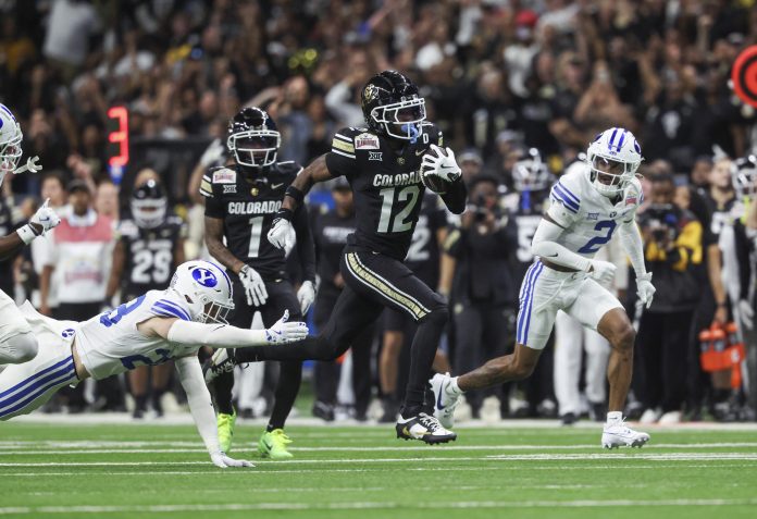 Colorado Buffaloes wide receiver Travis Hunter (12) runs with the ball during the second quarter against the Brigham Young Cougars at Alamodome.