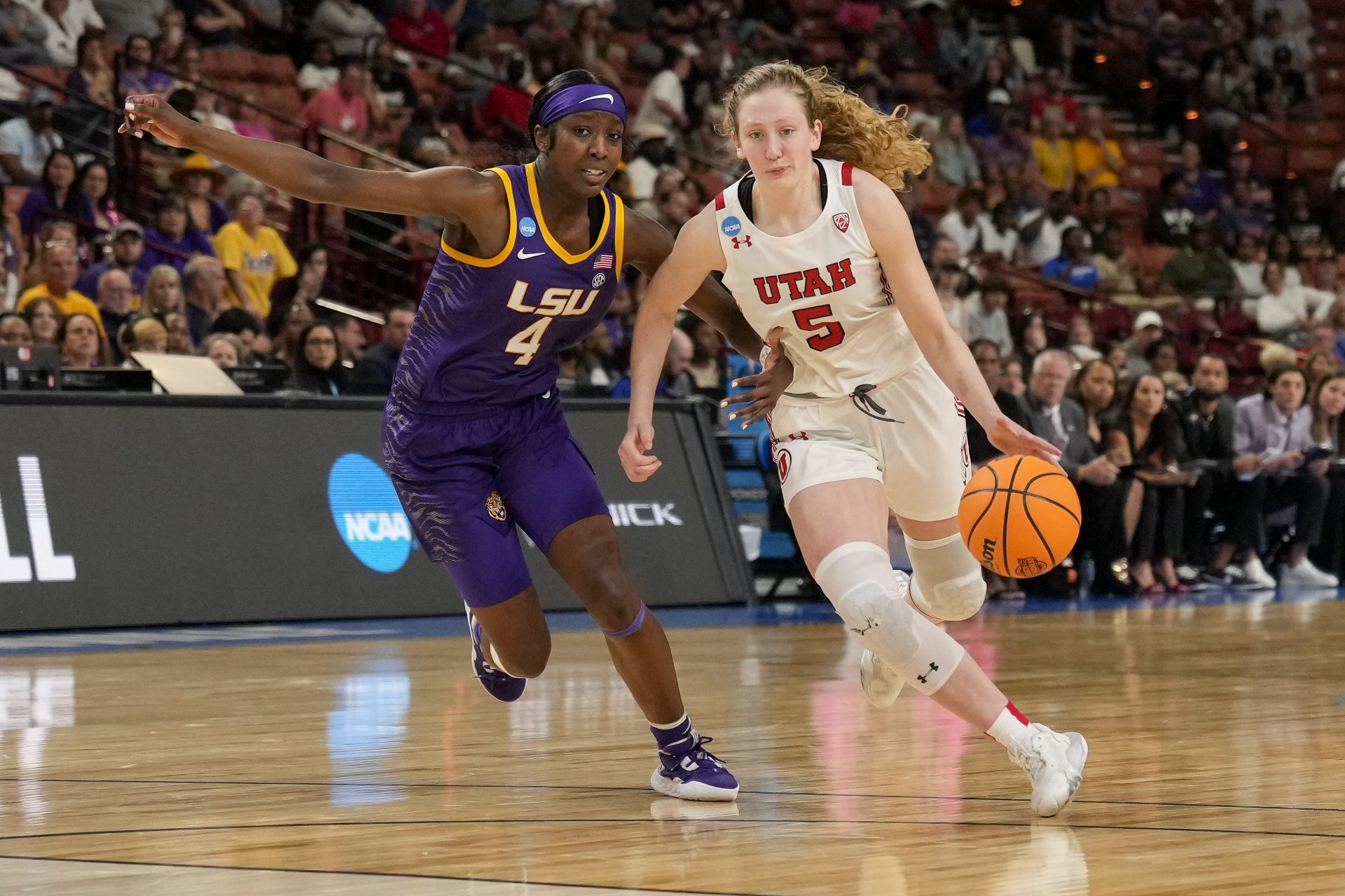 Utah Utes guard Gianna Kneepkens (5) drives to the basket guarded by LSU Lady Tigers guard Flau'jae Johnson (4) during the second half at the NCAA Women s Tourney at Bon Secours Wellness Arena.