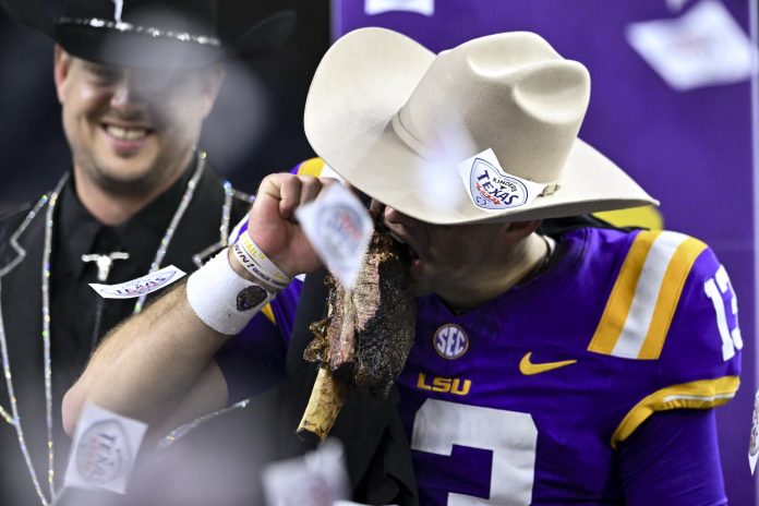 LSU Tigers quarterback Garrett Nussmeier (13) takes a bite of the Kinder’s BBQ rib during the post game celebration at NRG Stadium. The Tigers defeat the Bears 44-31.