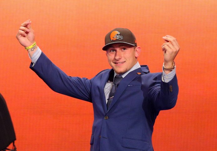 Johnny Manziel (Texas A&M) gestures on stage after being selected as the number twenty-two overall pick in the first round of the 2014 NFL Draft to the Cleveland Browns at Radio City Music Hall.