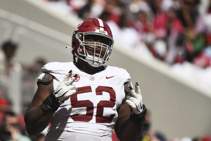 Alabama offensive lineman Tyler Booker (52) celebrates after the offense scored a touchdown during the A-Day scrimmage at Bryant-Denny Stadium.