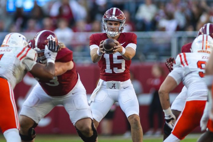 Alabama Crimson Tide quarterback Ty Simpson (15) receives a snapped ball against the Mercer Bears during the third quarter at Bryant-Denny Stadium.