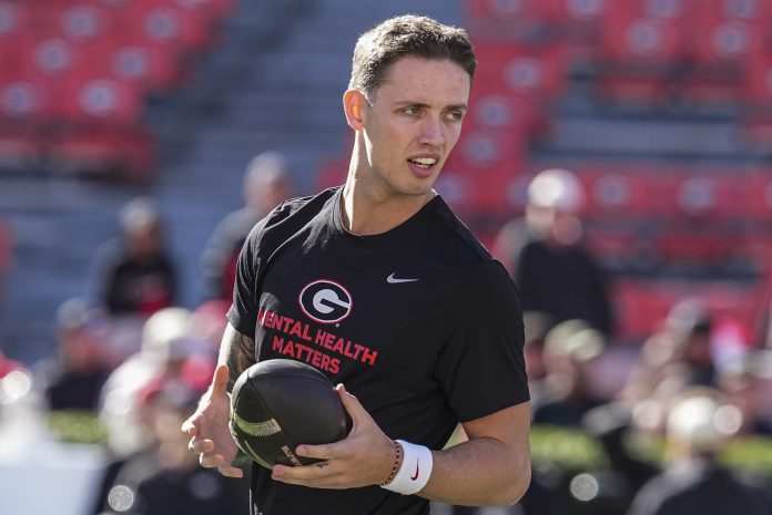 Georgia Bulldogs quarterback Carson Beck (15) shown on the field prior to the game against the Massachusetts Minutemen at Sanford Stadium.