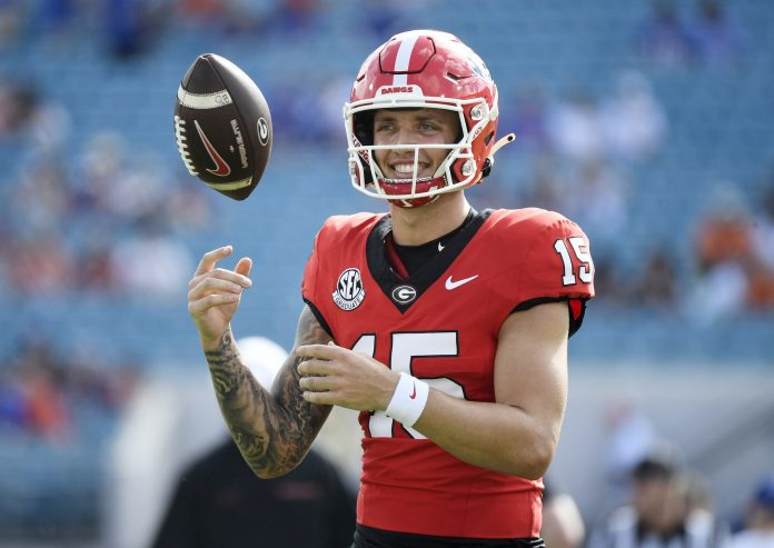 Georgia Bulldogs quarterback Carson Beck (15) warms up before a game against the Florida Gators at EverBank Stadium.