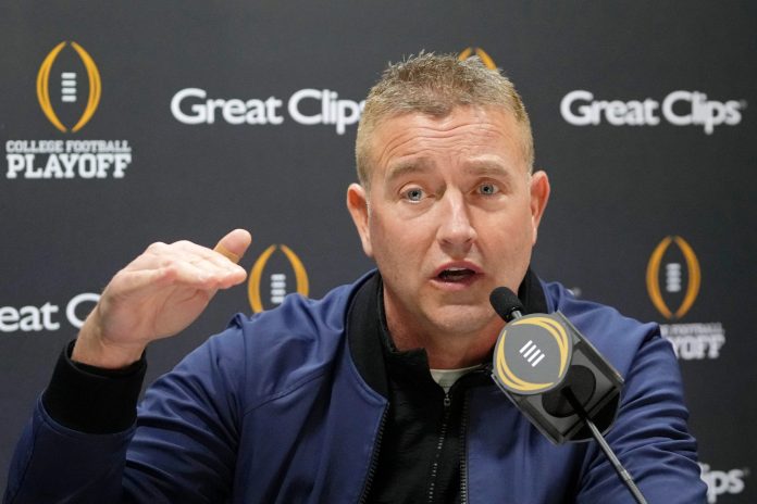 Kirk Herbstreit talks to the media during 2025 CFP National Championship Media Day at Georgia World Congress Center, Building A.