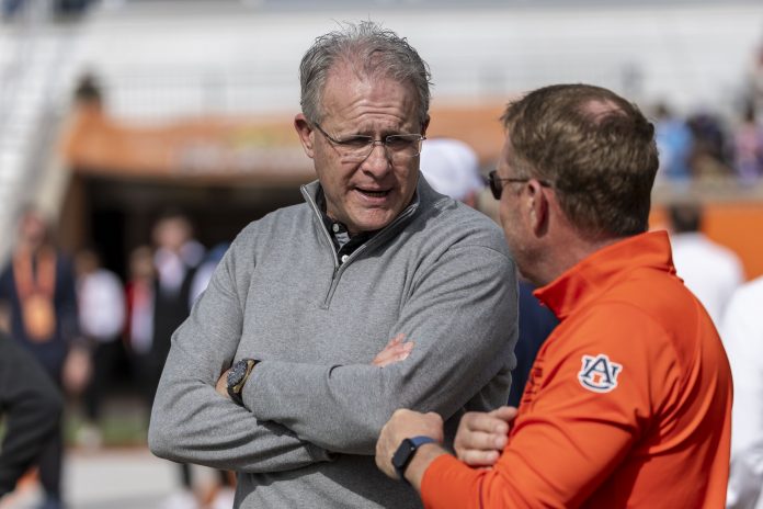 Florida State offensive coordinator Gus Malzahn talks with Auburn head coach Hugh Freeze during Senior Bowl practice for the American team at Hancock Whitney Stadium. Malzahn is a former Auburn football head coach.