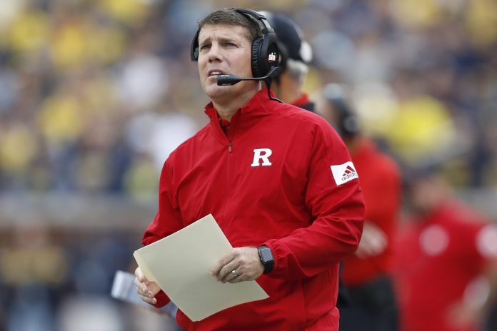 Rutgers Scarlet Knights head coach Chris Ash looks up at the scoreboard during the first quarter against the Michigan Wolverines at Michigan Stadium.