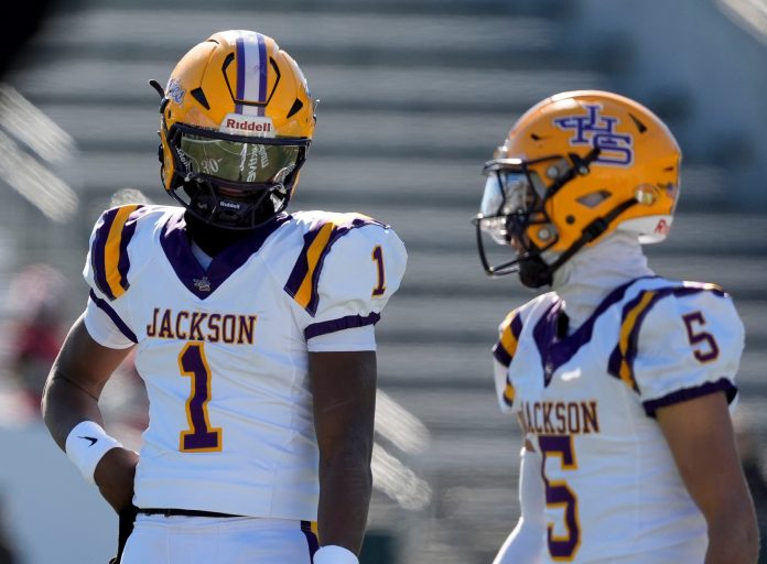 Jackson's Landon Duckworth (1) and Jackson's Chris Payne (5) talk during a timeout during the game with Cherokee County at Protective Stadium in the AHSAA 4A State Championship game.