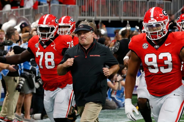 Georgia coach Kirby Smart leads his team onto the field before the start of the NCAA Aflac Kickoff Game in Atlanta, on Saturday, Aug. 31, 2024.