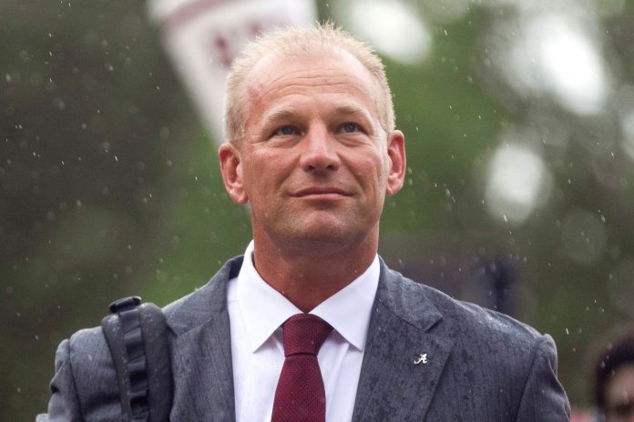 Fans watch as Alabama Crimson Tide head coach Kalen DeBoer walks down the Walk of Champions with his team outside of Bryant-Denny Stadium.