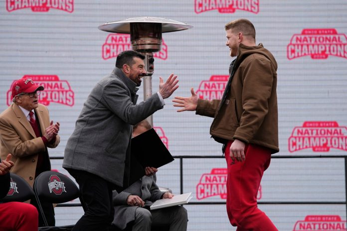 Ohio State Buckeyes head coach Ryan Day high fives defensive end Jack Sawyer during the Ohio State Buckeyes College Football Playoff National Championship celebration at Ohio Stadium in Columbus on Jan. 26, 2025.