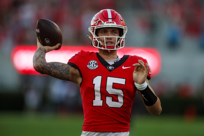 Georgia Bulldogs quarterback Carson Beck (15) warms up against the Mississippi State Bulldogs in the third quarter at Sanford Stadium.