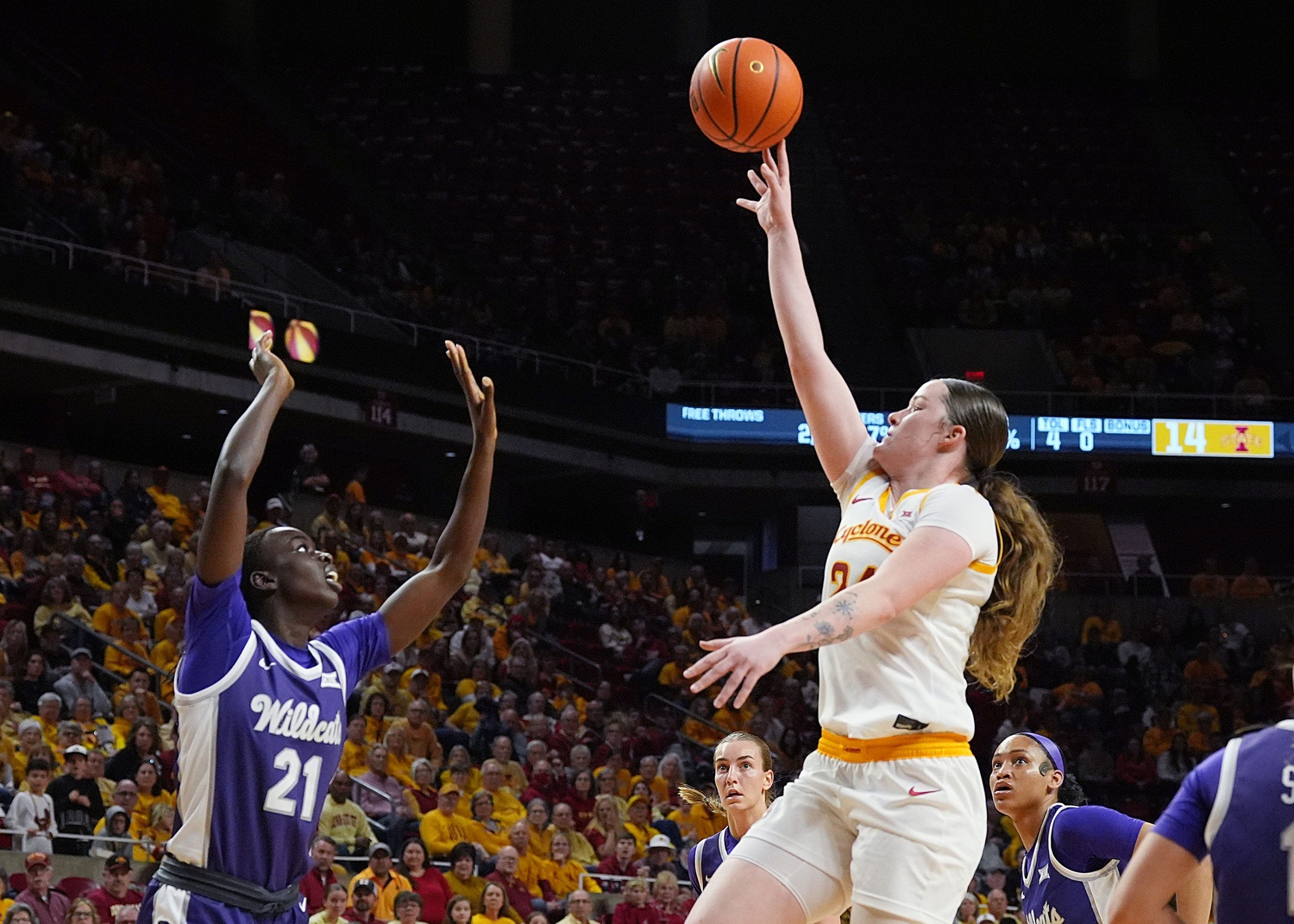 Iowa State Cyclones' forward Addy Brown (24) shoots the ball over Kansas State Wildcats forward Eliza Maupin (21) during the first quarter in the Big-12 women’s basketball at Hilton Coliseum on Sunday, March 2, 2025, in Ames, Iowa.